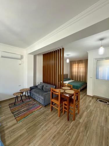a living room with a couch and a table at Appartments Kristi&Iris in Vlorë