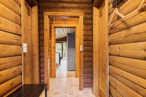 a hallway in a log cabin with wooden walls at LF14362-Roslev-Nautrupvej-62 in Roslev