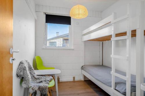 a small bedroom with a bunk bed and a desk and a chair at LF888-Snedsted-Over-Reese-5 in Snedsted