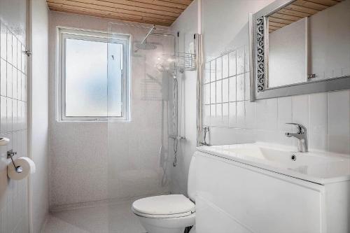 a white bathroom with a toilet and a sink at LF888-Snedsted-Over-Reese-5 in Snedsted