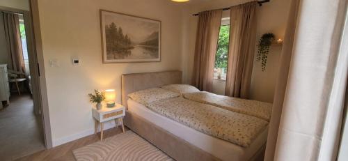 a small bedroom with a bed and a window at Domki Partecznik Wisla in Wisła