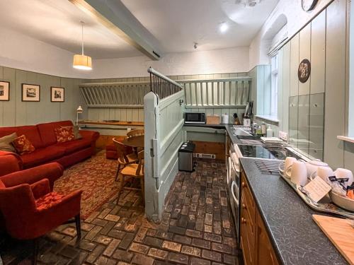 a kitchen and living room with a red couch at Stables - Uk51018 in Louth