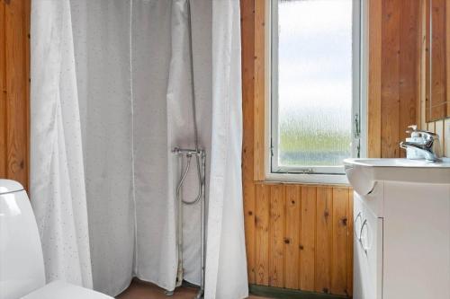 a bathroom with a shower curtain and a sink at LF14092-Roslev-Eskovvej-92 in Roslev