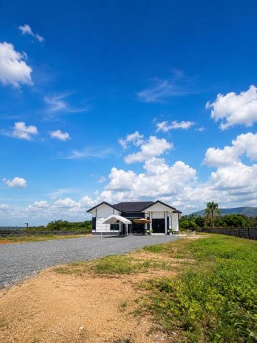 a house on the side of a road at Homestay ZASS in Arau