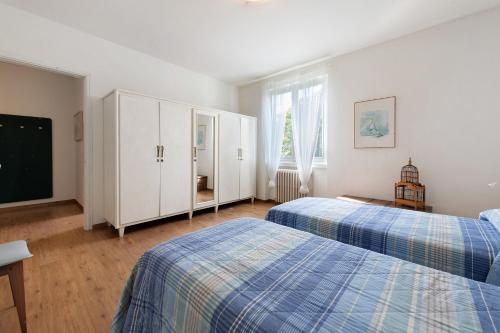 a bedroom with two beds and a tv in it at Casa al Lago in Sulzano