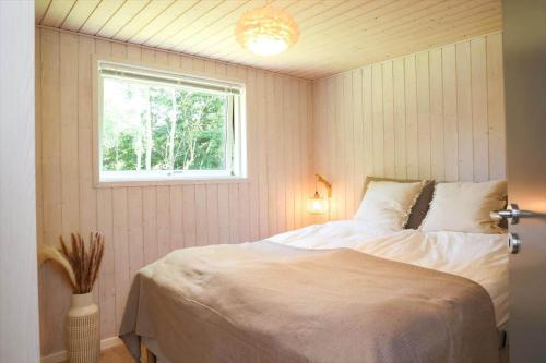 a bedroom with a white bed and a window at 10055-1-Rorvig-Lindevangen-4 in Rørvig