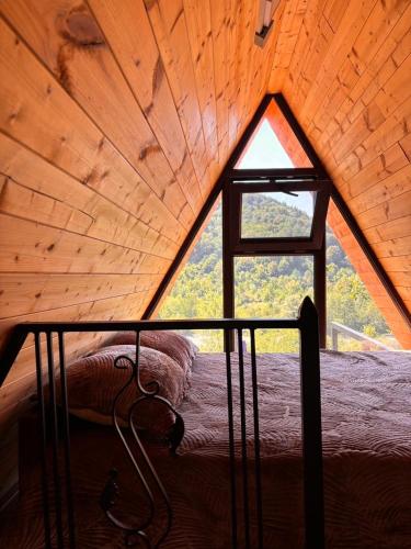 a bedroom in a tree house with a window at Helios racha in Ambrolauri