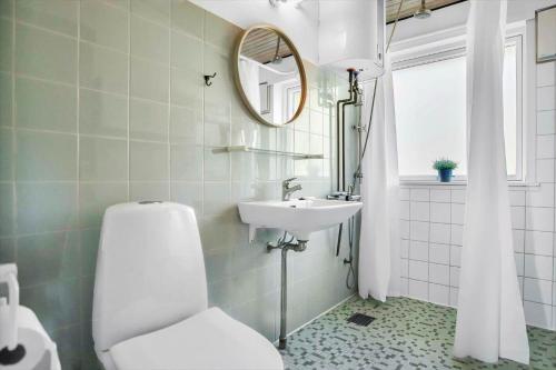 a bathroom with a toilet and a sink at 18008-Holbaek-Raevestien-5 in Holbæk