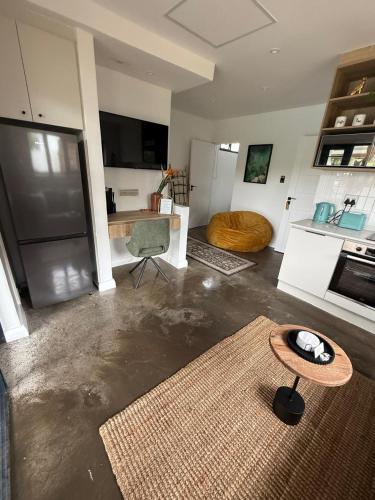 a living room with a table and a kitchen at RElaxed city living in Port Elizabeth