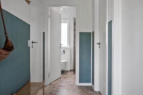 a hallway with a bathroom with a toilet and a sink at LF12003-Spottrup-Molleparken-32 in Spottrup