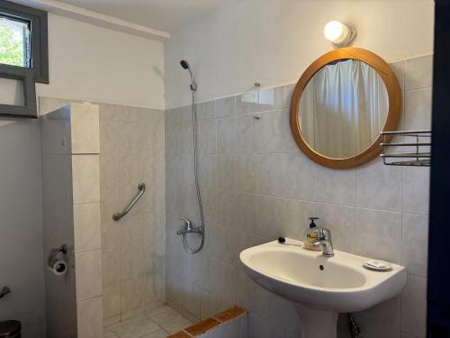 a bathroom with a sink and a mirror at Ageranos in Vathi