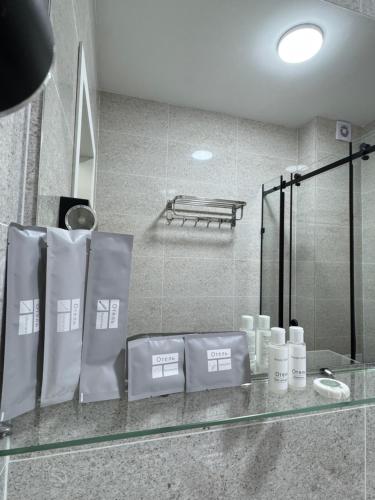 a glass counter in a bathroom with towels on it at Өркүндө in Chon-Sary-Oy