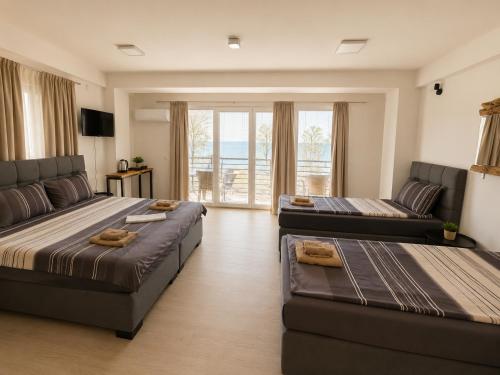 a living room with two beds and a couch at Villa Natali in Ohrid