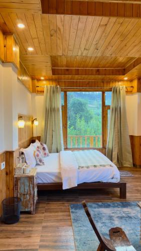 a bedroom with a bed and a large window at Almost Home in Shangarh