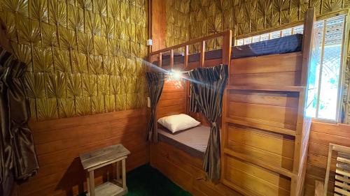 a small cabin with a bunk bed in it at Wonderful Hostel Trincomalee in Trincomalee