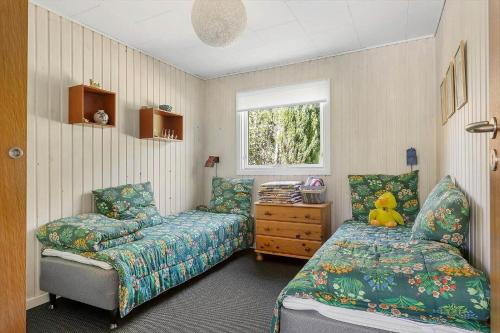 a bedroom with a bed and a couch and a window at LF16024-Farso-Kjeldhoj-24 in Farsø
