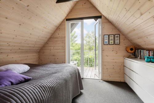 a bedroom with a large bed and a window at LF15103-Farso-Rorsangervej-3 in Farsø