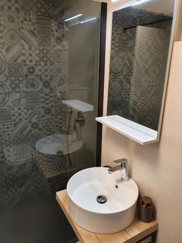 a bathroom with a white sink and a shower at Apartments Toni Two in Igrane