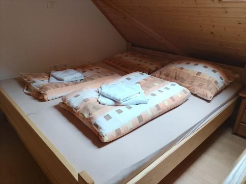 two beds sitting on a mattress in a room at Soča Trails Apartment #6 in Log Čezsoški