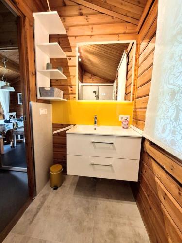 a bathroom with a sink and a mirror at Ferienhaus Neckar 58 in Hayingen