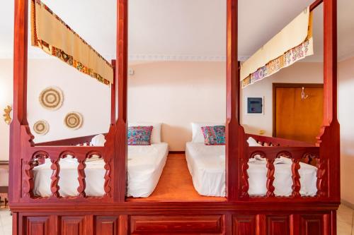 a room with two bunk beds and a couch at Maria's Studio 1 in Karpathos