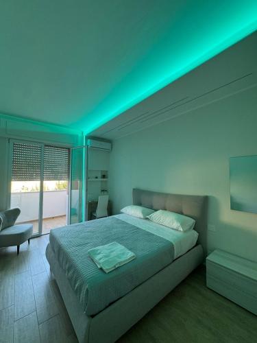 a bedroom with a bed with a green light at Stazione 21 - Pescara Loft in Pescara