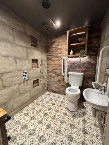 a bathroom with a toilet and a sink at Accommodation Bristol Airport in Redhill