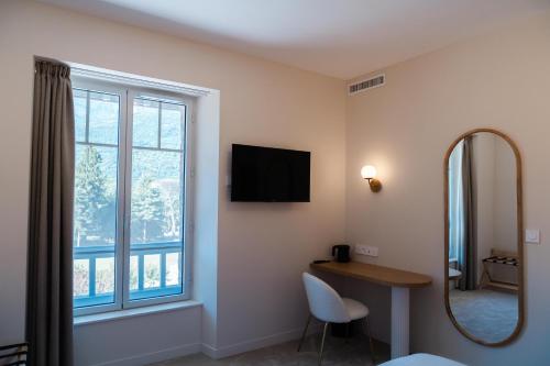 a room with a mirror and a desk and a window at Domaine de Beaucens in Beaucens