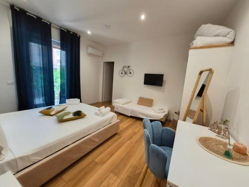 a large room with two beds and a chair at B&B Magnolie in Palermo