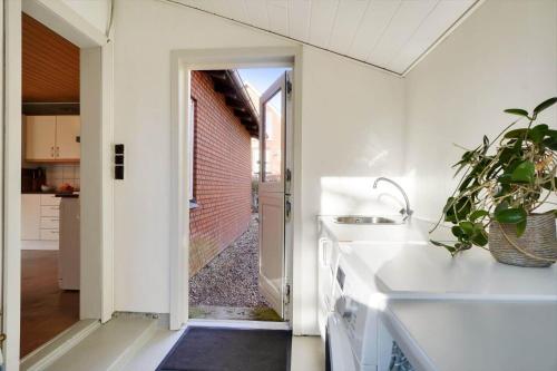 a kitchen with a door open to a courtyard at LF10313-Hurup-Thy-Fjordstraede-13 in Doverodde