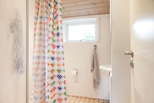 a bathroom with a shower curtain with a window at 13374-1-Vig-Thorsvej-4 in Vig