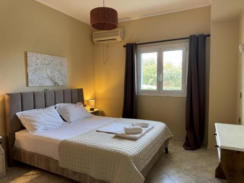 a bedroom with a large bed with a window at Georgia in Gythio