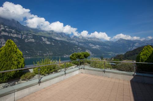 a balcony with a view of a lake and mountains at Hotel Neu-Schönstatt in Quarten