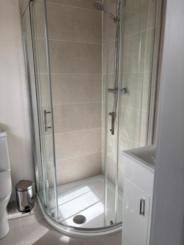 a shower with a glass door in a bathroom at Lidia House in Westport