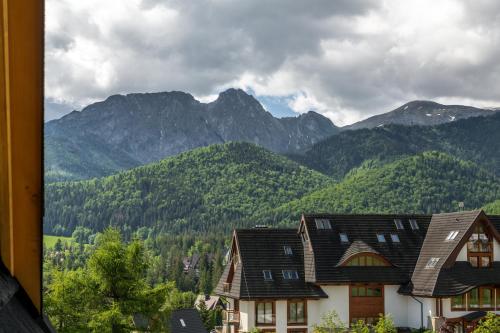 a view of the mountains from a house at TatryTop Giewont House Wellness in Kościelisko