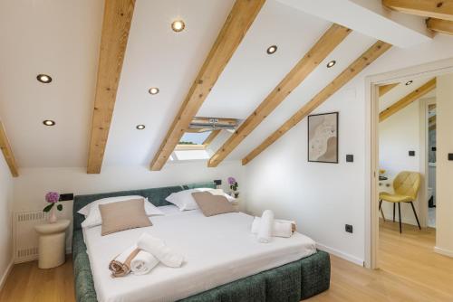 a bedroom with a large bed with white sheets at Luxury room Sunset Cavtat in Cavtat