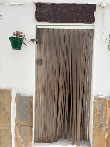 a door with a potted plant on a building at Las Casitas de mi Abuela in Casares