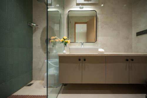 a bathroom with a sink and a mirror at Hotel Meera Palace in Varanasi