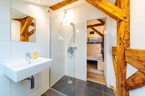 a bathroom with a white sink and a shower at Hideout in Morzine