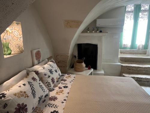 a bedroom with a bed and a fireplace at La Dimora del Gigante in Carovigno