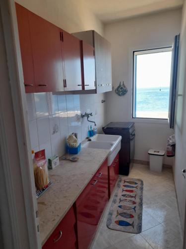 a small kitchen with a sink and a window at Casa vacanze levanzo in Levanzo