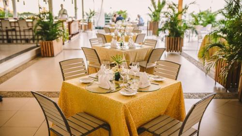 a dining room with tables and chairs with at Hotel Montana in Petionville