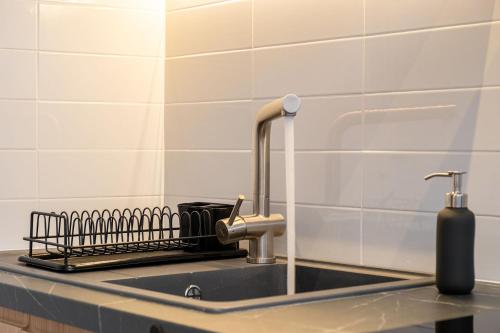 a kitchen sink with a faucet and a soap dispenser at eu Τhea Apt Samos - Sandy Beach & Amazing View in Psili Ammos