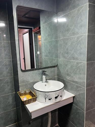 a bathroom with a sink and a mirror at Sa Pa Camellia Hotel in Sapa