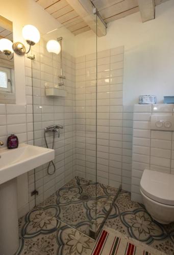 a bathroom with a toilet and a sink at Zlatar Zen Chalet in Vukovina