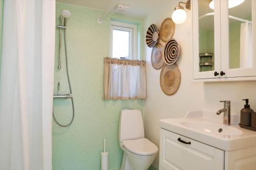 a bathroom with a shower and a toilet and a sink at 13503-Vig-Lyngvej-107-4 in Vig