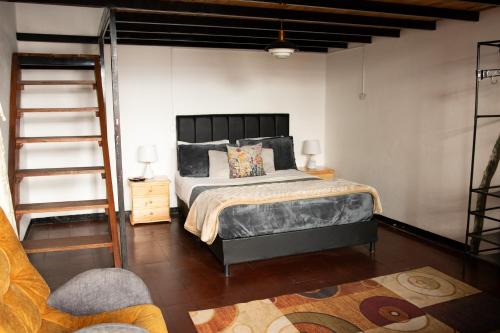 a bedroom with a king sized bed and a ladder at Casa Samor in Bogotá
