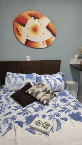 a bedroom with a bed with a clock on the wall at POUSADA MEGA in Marataizes