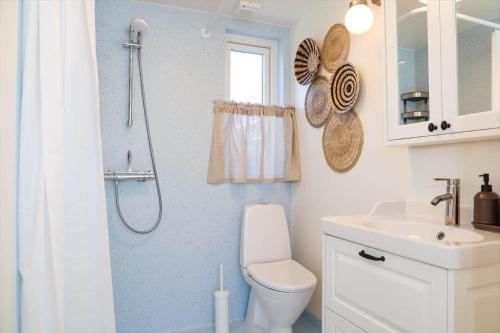 a bathroom with a toilet and a sink and a shower at 13502-Vig-Lyngvej-107-3 in Vig