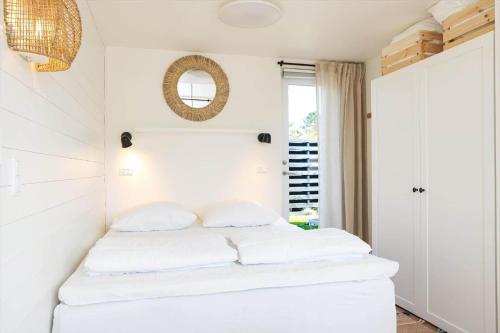 a bedroom with white walls and a bed with white pillows at 13502-Vig-Lyngvej-107-3 in Vig